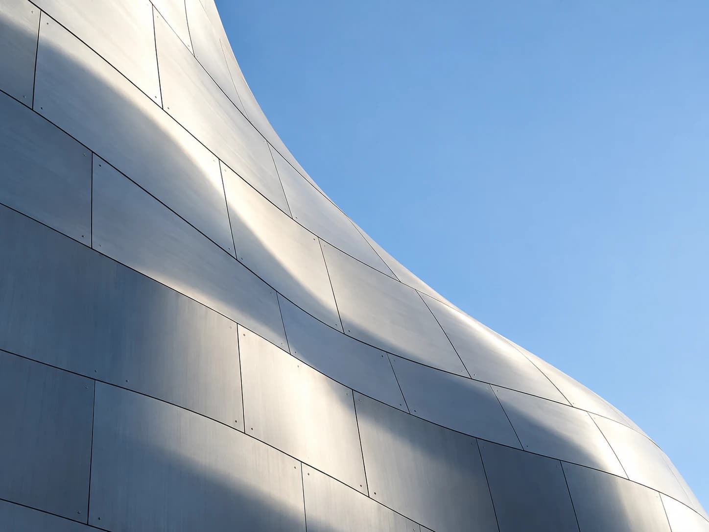 A contemporary building facade reaching toward an open sky